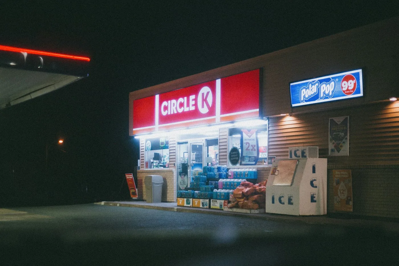 Illuminated commercial retail signage on a storefront — representative service image